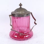 An early 20th century spiral cranberry glass biscuit jar, with swing-handled electroplate mounts,