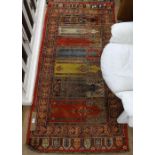 A red ground family prayer rug, 200cm x 95cm