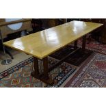 A Heal's style Arts and Crafts golden oak rectangular refectory dining table, on quadruple canted
