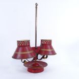 A 19th century Toleware gilded and red painted brass rise and fall adjustable double candle stand