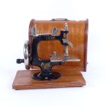 A Vintage Japanese portable Lead sewing machine, in bentwood travelling case, machine length 20cm