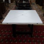 A Conran envelope extending dining table, the white formica top on black lacquered 4-gateleg base,
