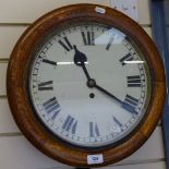 An early 20th century oak-cased circular dial 30-hour wall clock, dial diameter 30cm