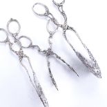 3 pairs of Continental silver pastry tongs, allover pierced and foliate decoration, 4.4oz total (3