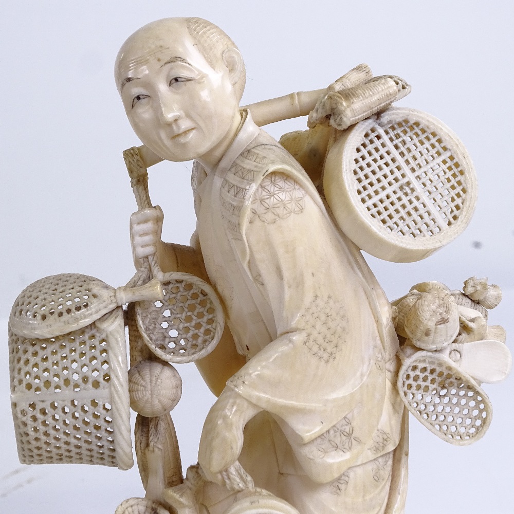 A Japanese ivory okimono of a basket seller, Meiji Period, with inset signed jade plaque under base, - Image 3 of 3