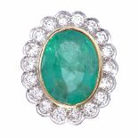 A large oval emerald and diamond cluster ring, central oval mixed-cut emerald approx 6.75ct,