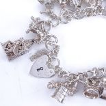 A modern sterling silver charm bracelet with various charms, bracelet length 16cm, 60.3g Very good