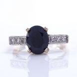 A late 20th century 18ct gold sapphire and diamond dress ring, sapphire length 9.2mm, size N, 4.5g