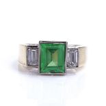 A late 20th century 18ct gold 3-stone synthetic emerald and diamond dress ring, total emerald-cut