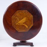 A 19th century mahogany doll's tilt-top dining table, with bird marquetry inlaid top and platform