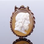 A relief carved shell cameo panel pendant in unmarked gold rope twist frame, shell panel length 20.