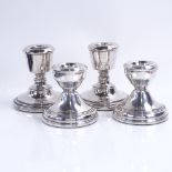 4 silver-mounted squat candlesticks, largest height 7cm, loaded bases Good overall condition,