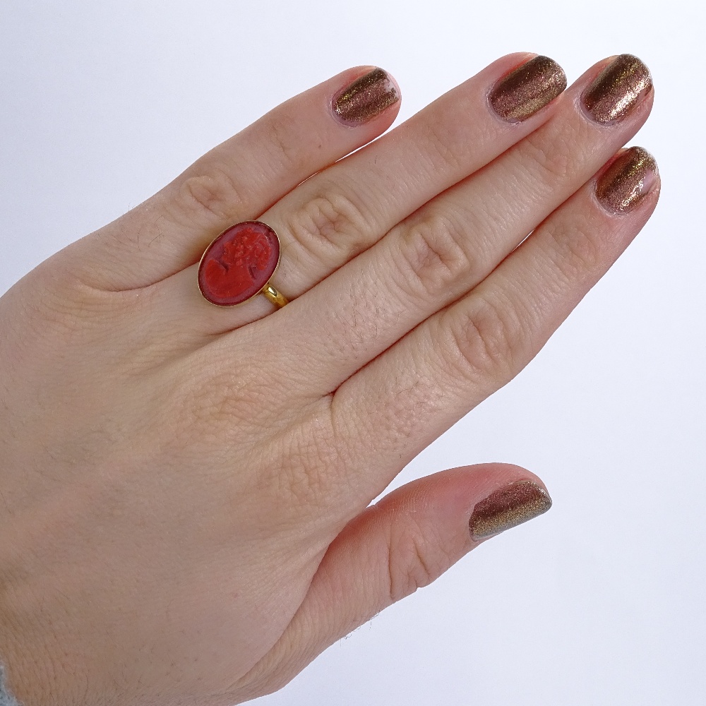 An unmarked silver-gilt relief carved coral cameo ring, setting height 16.7mm, size J, 2.5g Good - Image 5 of 5