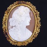 A 19th century relief carved shell cameo brooch, depicting Classical female profile, in unmarked
