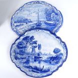 A pair of Delft blue and white pottery wall plaques, with painted river scenes, width 38cm, height