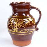 A slip glaze stoneware pottery jug, height 21cm