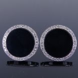 A pair of 18ct white gold onyx and diamond cluster cufflinks, plain circular panels set with onyx