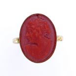 An unmarked silver-gilt relief carved coral cameo ring, setting height 16.7mm, size J, 2.5g Good