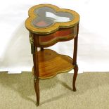 A reproduction mahogany clover shaped vitrine table, with shaped glass panels and ormolu mounts,