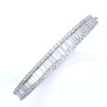 A 7.5ct diamond cluster hinged bangle/bracelet, set with graduated baguette diamonds within a