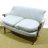 A small Edwardian upholstered parlour sofa with carved show-wood arms, width 125cm