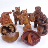 A group of Japanese carved wood netsuke and okimono, including a rat carrying a backpack, height 6cm