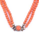A 19th century double-strand graduated coral bead necklace on unmarked yellow metal clasp,