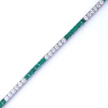 An emerald and diamond tennis line bracelet, set at alternates with calibre-cut emeralds and round