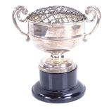 A George V silver pedestal trophy design rose bowl with fitted gauze and ebonised stand, by Henry