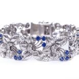 A sapphire and diamond floral bracelet, floral spray panels set with round-cut sapphires and