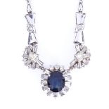 A modern 18ct white gold sapphire and diamond cluster necklace, set with 2.85ct oval-cut sapphire,