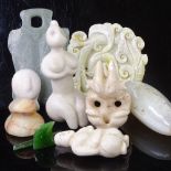 A collection of stone carvings, including Chinese jade, South American carvings, and Maori green