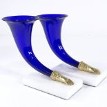 A pair of Bristol blue glass cornucopia vases, on white marble bases, height 17cm Very good
