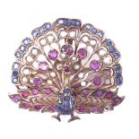 An Indian unmarked yellow metal ruby sapphire and pearl peacock pendant/brooch, pendant height 45.