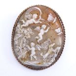 A 19th century relief carved shell panel cameo brooch, depicting cherubs in a garden, in unmarked