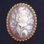 A late 20th century relief carved shell cameo brooch depicting spray of flowers, in 9ct gold rope