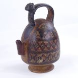 A 16th century Peruvian terracotta ceremonial chicha pot, with puma handle and geometric painted