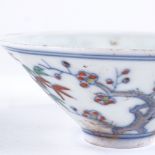 A Chinese porcelain tea bowl with painted blossom tree designs, 6 character mark, diameter 8.5cm