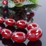 A long single-strand graduated cherry amber bead necklace, beads measuring from 12.7mm to 32.3mm,