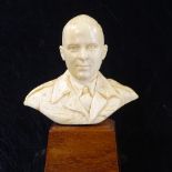 A Second War Period carved ivory bust of a British Army Officer, on wood plinth base, label on
