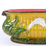 A 19th century Majolica Pottery oval jardiniere, with relief moulded lily flower designs, no factory