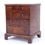 A Victorian amboyna apprentice chest of drawers, with brass handles and bracket feet, width 22cm,