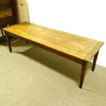 A large 19th century beech farmhouse table with 2.5cm thick plank top, on tapered legs, 248cm x 83cm