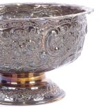 A late Victorian circular silver pedestal bowl, allover relief embossed floral and lattice