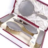 An Elizabeth II 6-piece silver-backed dressing table set, engine turned and floral engraved