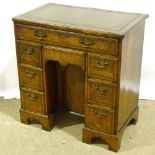 A small Queen Anne style walnut kneehole desk, with inset green leather top, alcove drawer and