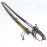 A Victorian Navy Officer's dress sword with brass hilt, etched blade and brass scabbard Blade in