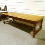 A large cherrywood refectory style farmhouse table, 2cm thick plank-top, with turned supports, end