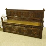 A 19th century French oak hall settle, with inset bobbin turned spindles and rising seat, length