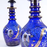 A pair of gilded blue glass Ottoman style large decanters, with portrait panels, largest height 57cm